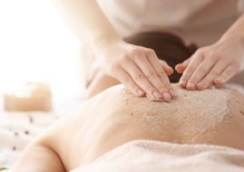 pessoa deitada de costas fazendo esfoliação corporal no Buddha Spa